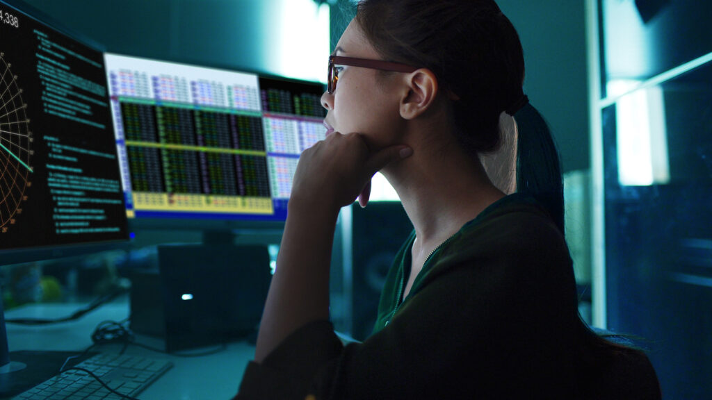 Woman monitoring computers