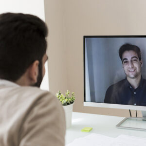 Stock image of a remote working on a video conference call with his AV integration company 